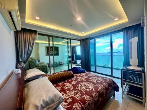 Spacious bedroom with large windows and ocean view