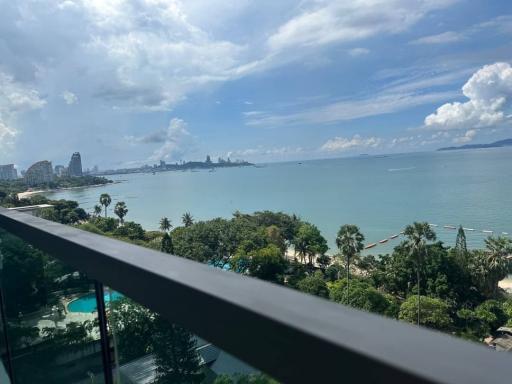 Panoramic seaside view from a balcony with a clear sky