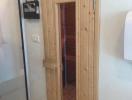 Wooden door leading to sauna adjacent to bathroom area