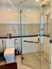 Modern bathroom with glass shower enclosure and white fixtures