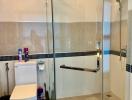 Modern bathroom with glass shower enclosure and white fixtures