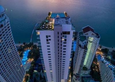 High-rise residential buildings by the seaside at twilight with vibrant sunset