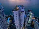 High-rise residential buildings by the seaside at twilight with vibrant sunset