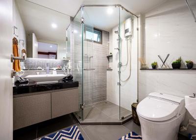 Modern bathroom interior with glass shower cubicle and vanity
