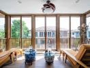 Bright sunroom with large windows and comfortable seating area