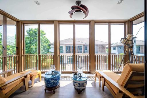 Bright sunroom with large windows and comfortable seating area