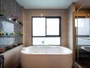 Modern bathroom interior with a large window, bathtub, and elegant tiling