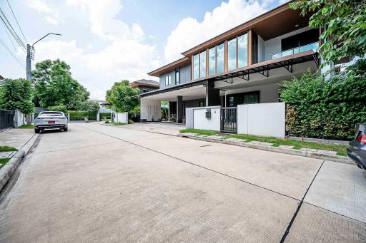 Modern two-storey house with large driveway and protective fencing