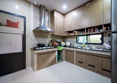 Modern kitchen with wooden cabinets and stainless steel appliances