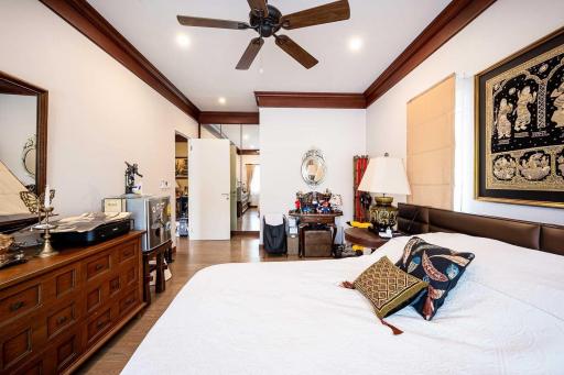Spacious bedroom with elegant decor and hardwood floor
