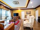 Spacious living room with elegant decor, comfortable seating, and ample lighting