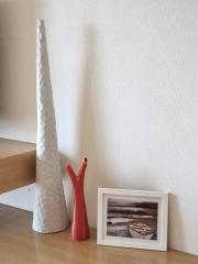 Modern decorative items on a wooden shelf in a living room setting