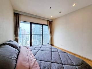 Spacious bedroom with large window and city view