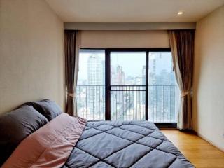 Cozy bedroom with large window and city view