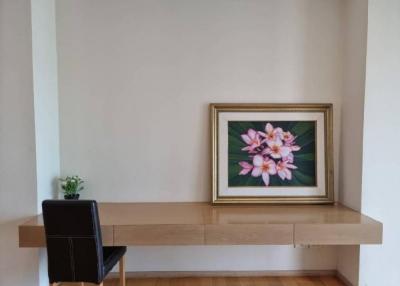 Minimalistic living room interior with a large framed floral artwork