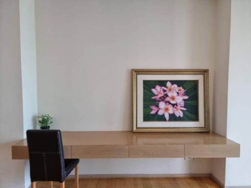 Minimalistic living room interior with a large framed floral artwork