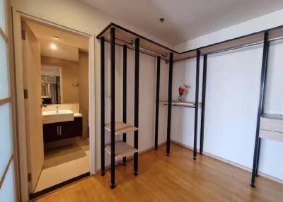 Spacious bedroom with mirrored wardrobe doors and wooden flooring