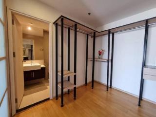 Spacious bedroom with mirrored wardrobe doors and wooden flooring