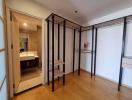 Spacious bedroom with mirrored wardrobe doors and wooden flooring