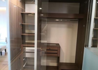 Built-in wooden wardrobe with shelving and drawers