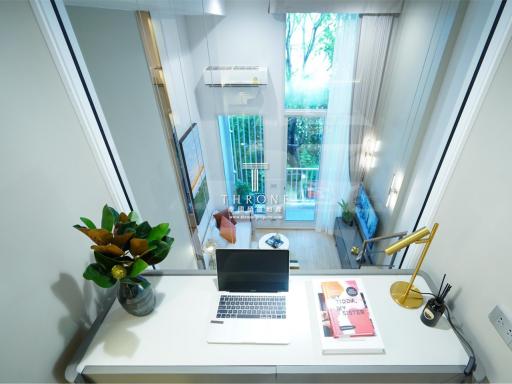 Modern bedroom with a laptop on desk and a view to the outside