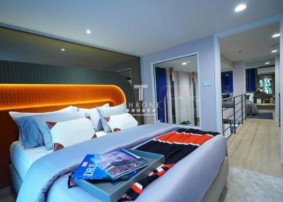 Elegant modern bedroom with adjoining living area