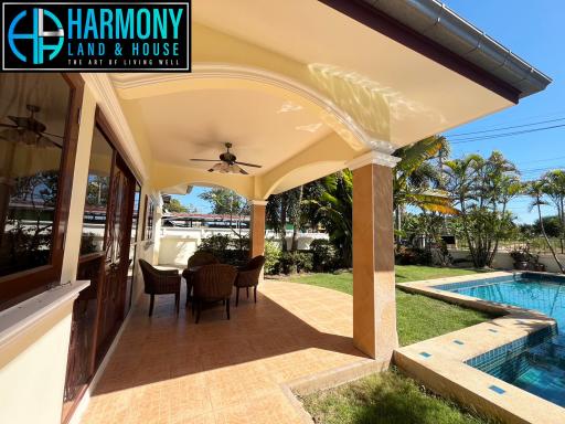 Spacious patio area with swimming pool and outdoor dining set