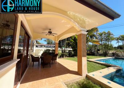 Spacious patio area with swimming pool and outdoor dining set
