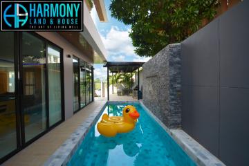 Bright and modern outdoor pool area with a large rubber duck float