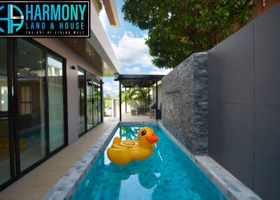 Bright and modern outdoor pool area with a large rubber duck float