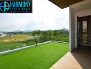 Spacious balcony with artificial grass overlooking scenic landscape