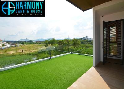 Spacious balcony with artificial grass overlooking scenic landscape