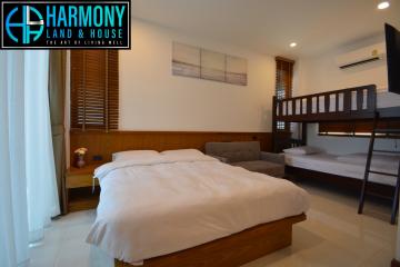 Spacious modern bedroom with large double bed and a bunk bed