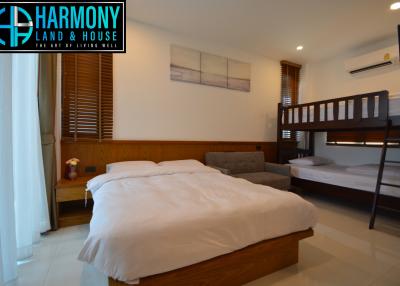 Spacious modern bedroom with large double bed and a bunk bed