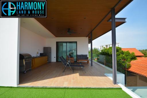 Spacious patio with outdoor furniture and barbecue grill