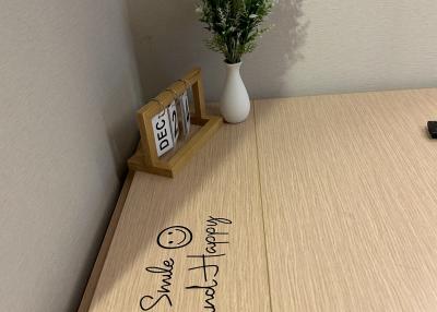 Office space with a desk, decorative plant, and calendar