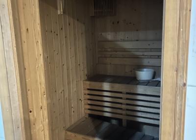 Wood-paneled home sauna with benches