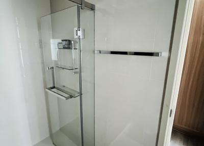 Modern bathroom with glass shower enclosure.