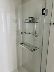 Modern frameless glass shower enclosure in a clean bathroom
