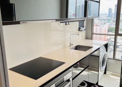 Modern kitchen with city view, featuring integrated appliances and ample counter space