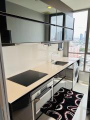Modern kitchen with city view, featuring integrated appliances and ample counter space
