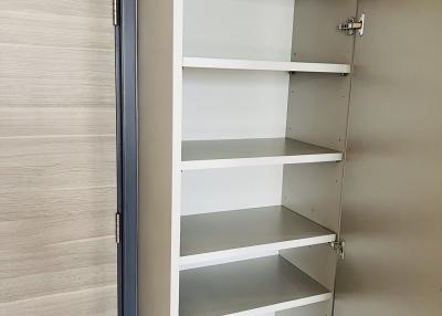 Empty white closet with open doors