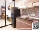 Modern kitchen with mosaic tile backsplash and wooden cabinets