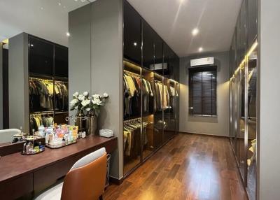 Spacious bedroom with large mirrored wardrobe and modern design