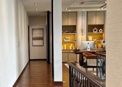 Modern kitchen with open shelving and a view into a corridor