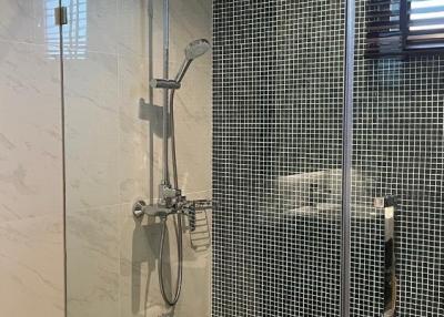 Modern bathroom with tiled shower and glass door