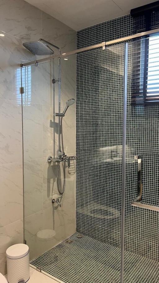 Modern bathroom with tiled shower and glass door