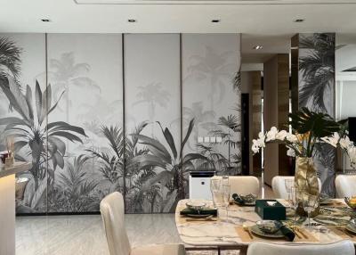 Elegant dining area with tropical wall mural and modern furnishings
