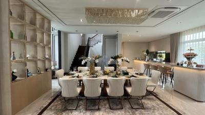 Elegant dining room with modern decor and adjacent kitchen