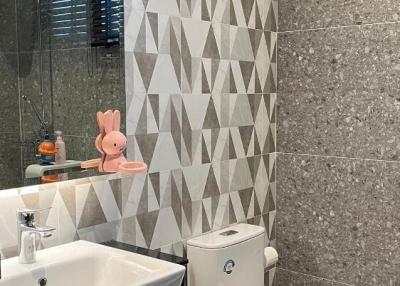 Modern bathroom with geometric tile wall design